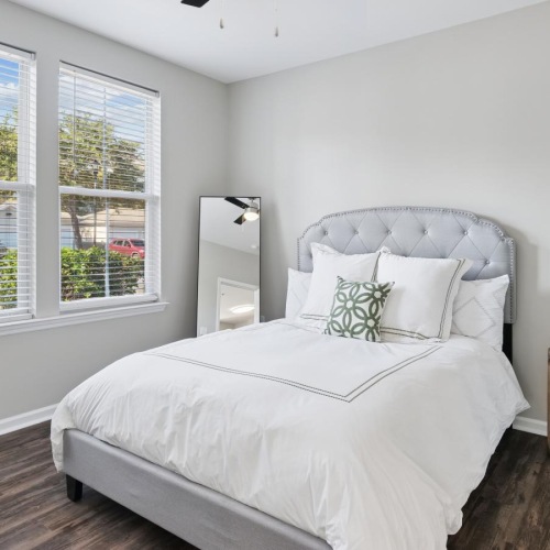 a bedroom with a bed and a fan