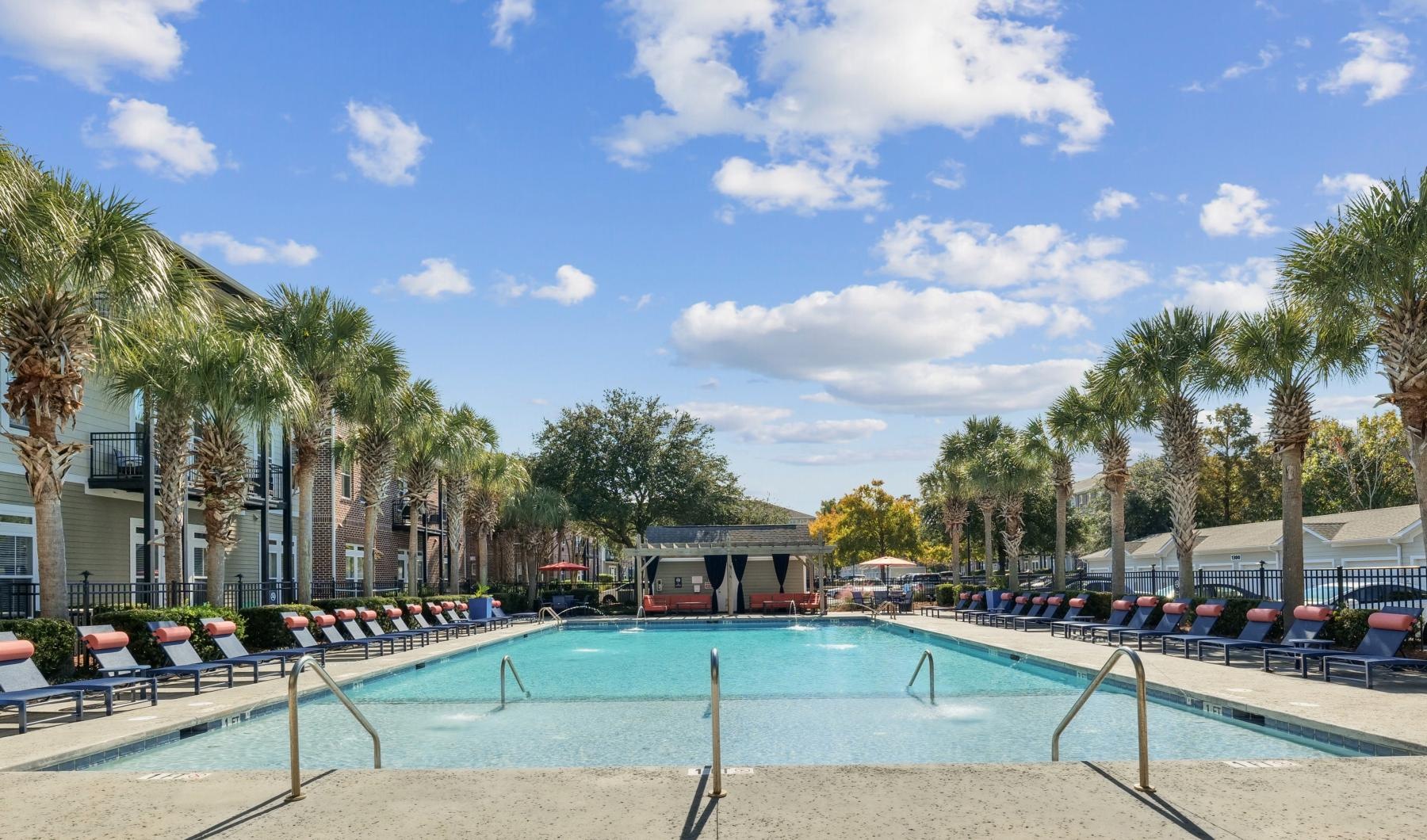 a swimming pool with chairs around it