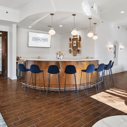 a clubroom with a pool table, bar and chairs