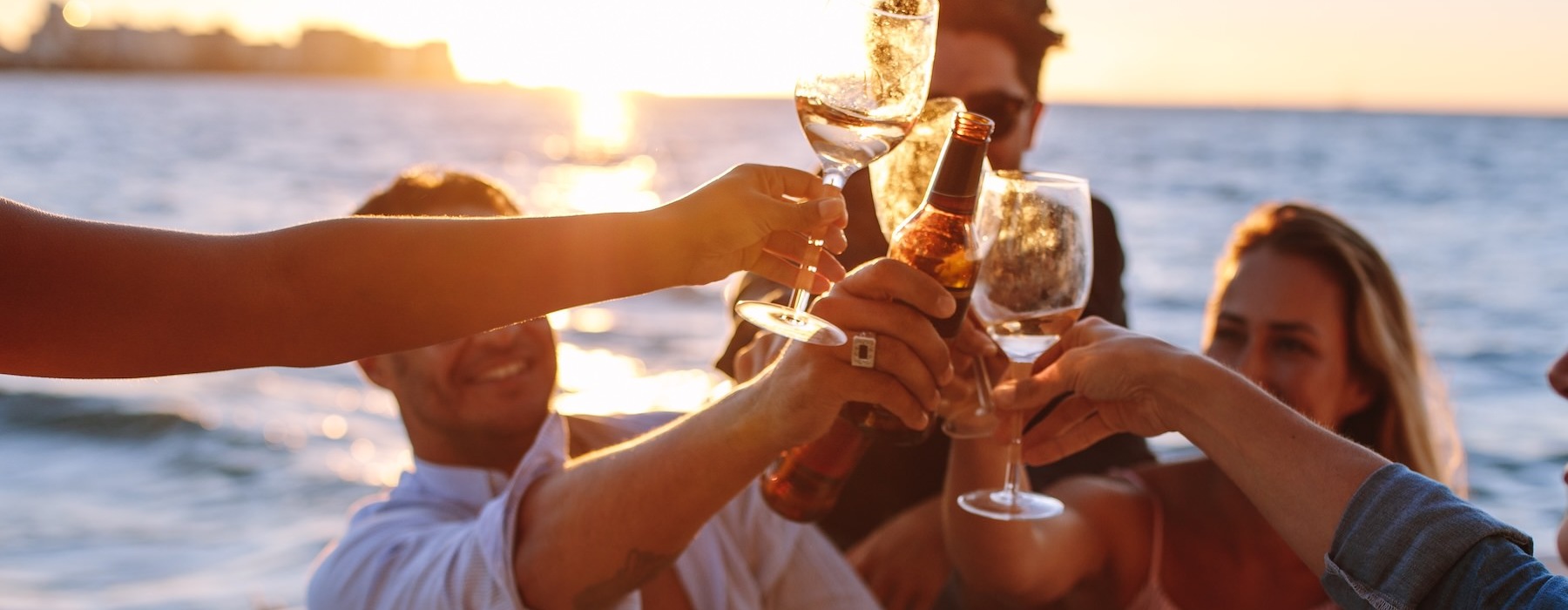 a group of people holding drinks on a boat