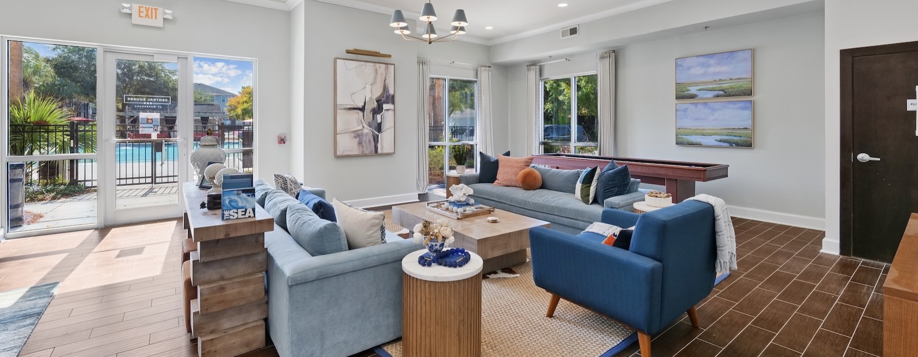 a clubroom with couches, tables and chairs